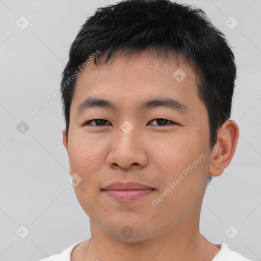 Joyful asian young-adult male with short  black hair and brown eyes