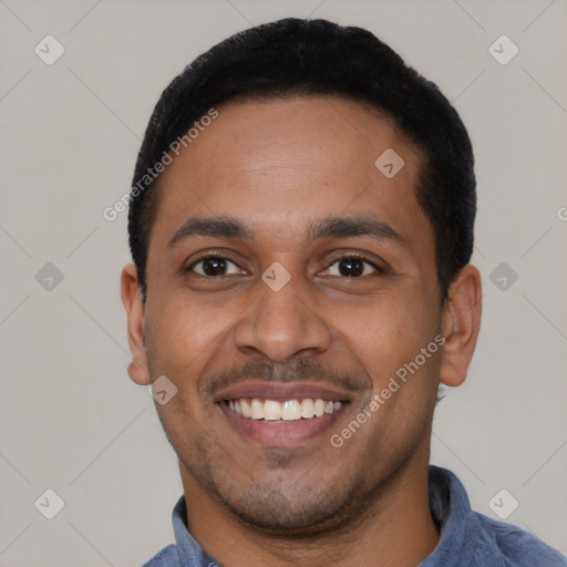 Joyful latino young-adult male with short  black hair and brown eyes