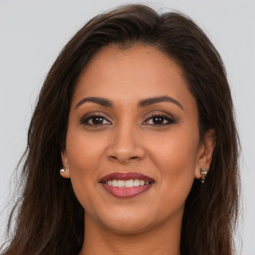 Joyful white young-adult female with long  brown hair and brown eyes