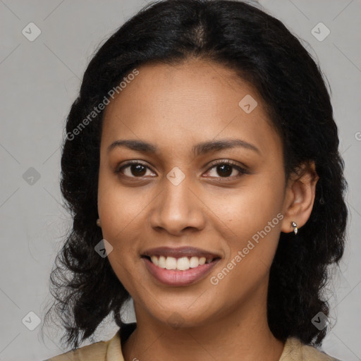 Joyful black young-adult female with long  black hair and brown eyes