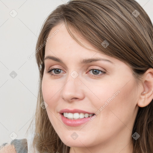 Joyful white young-adult female with long  brown hair and grey eyes