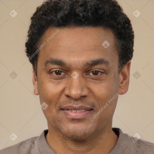 Joyful latino adult male with short  black hair and brown eyes