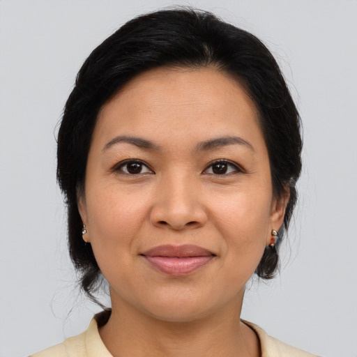 Joyful latino young-adult female with medium  brown hair and brown eyes