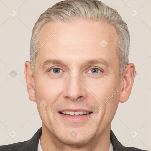 Joyful white adult male with short  brown hair and grey eyes