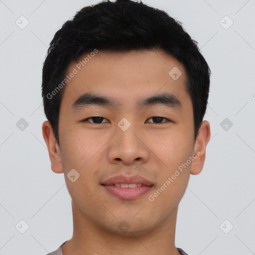 Joyful asian young-adult male with short  black hair and brown eyes