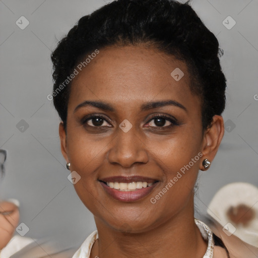 Joyful black young-adult female with short  brown hair and brown eyes