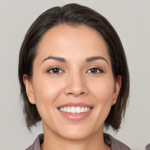 Joyful white young-adult female with medium  brown hair and brown eyes