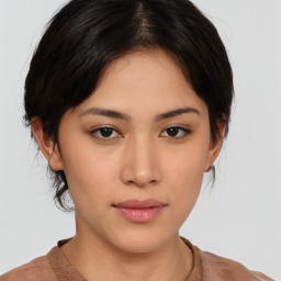 Joyful asian young-adult female with medium  brown hair and brown eyes