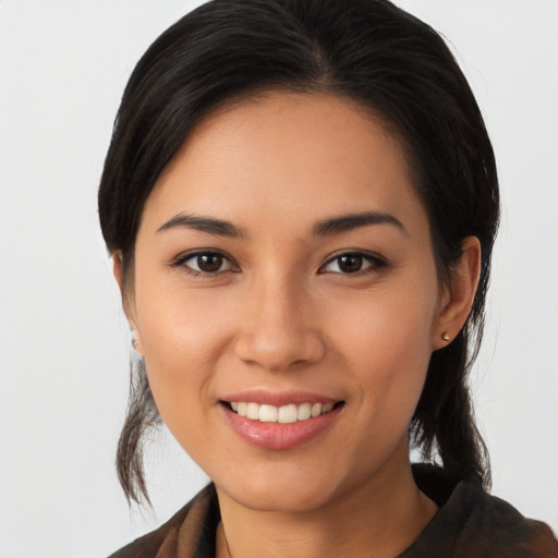 Joyful latino young-adult female with medium  brown hair and brown eyes