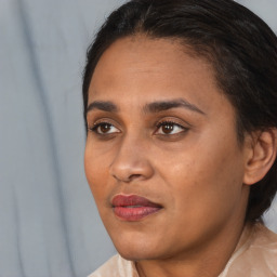 Joyful black young-adult female with medium  brown hair and brown eyes