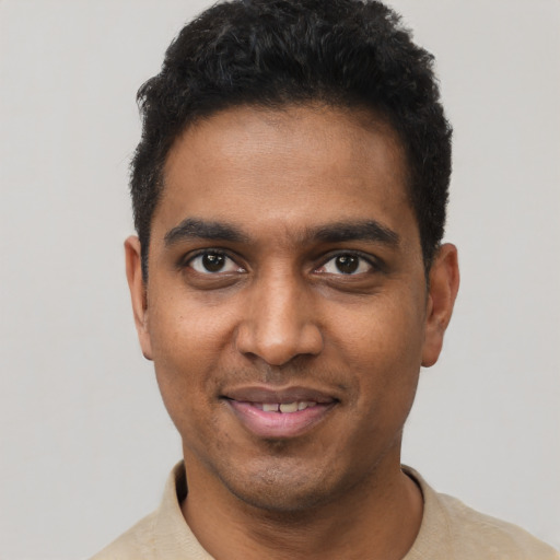 Joyful black young-adult male with short  black hair and brown eyes
