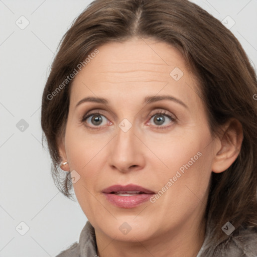 Joyful white adult female with medium  brown hair and grey eyes