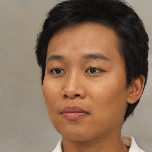 Joyful asian young-adult female with short  brown hair and brown eyes