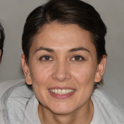 Joyful white adult female with medium  brown hair and brown eyes