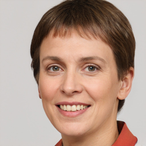 Joyful white adult female with short  brown hair and grey eyes