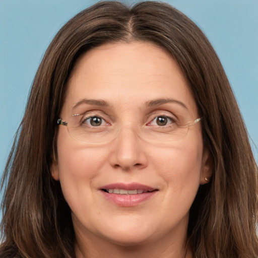 Joyful white adult female with long  brown hair and brown eyes