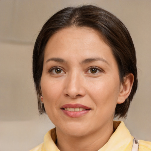 Joyful white adult female with medium  brown hair and brown eyes