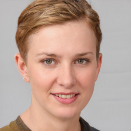 Joyful white young-adult female with short  brown hair and blue eyes