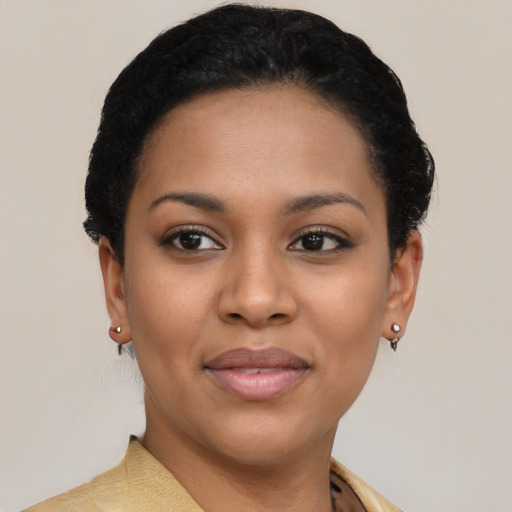 Joyful black young-adult female with short  black hair and brown eyes