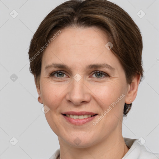 Joyful white adult female with short  brown hair and grey eyes