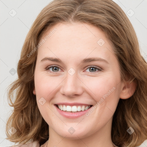 Joyful white young-adult female with medium  brown hair and blue eyes