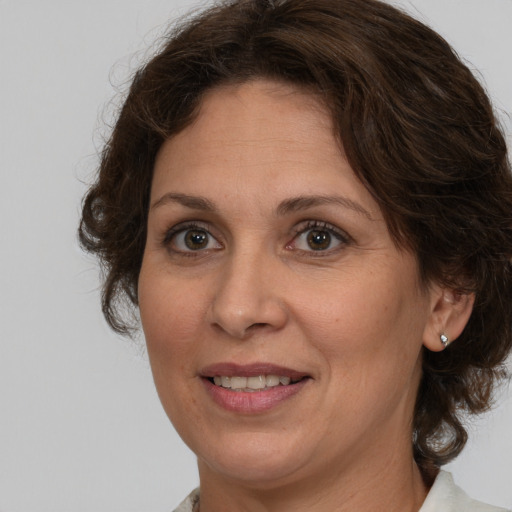 Joyful white adult female with medium  brown hair and brown eyes