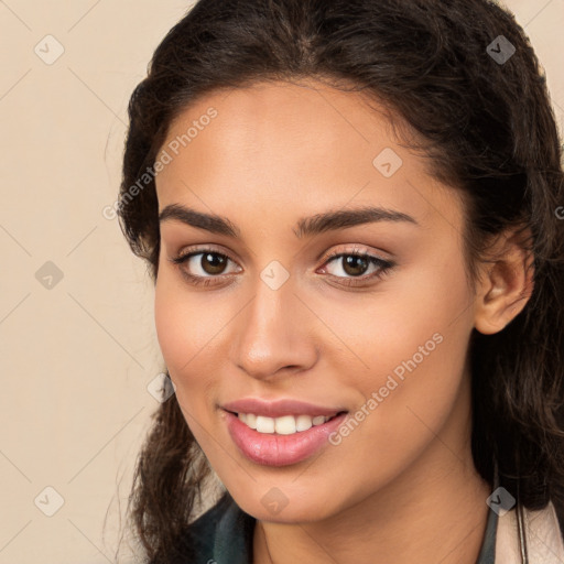 Joyful white young-adult female with long  brown hair and brown eyes