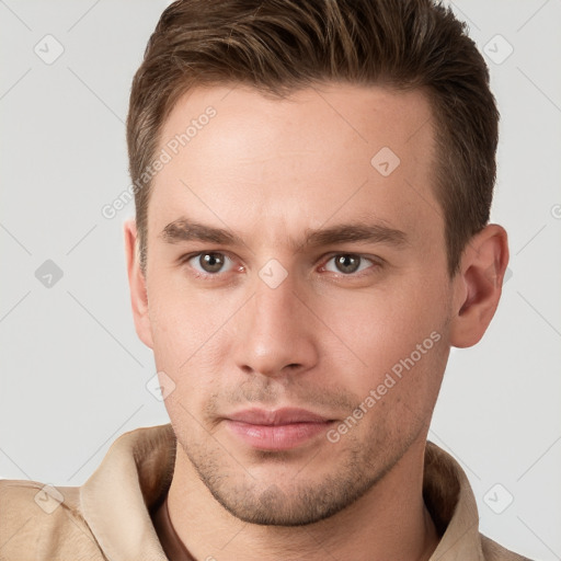 Neutral white young-adult male with short  brown hair and grey eyes