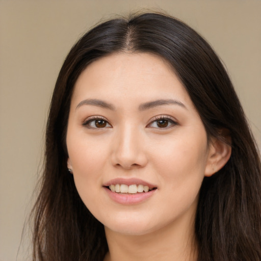 Joyful asian young-adult female with long  brown hair and brown eyes