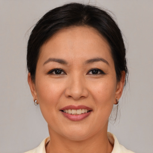 Joyful asian young-adult female with medium  brown hair and brown eyes