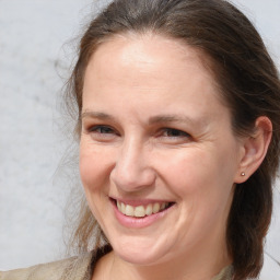 Joyful white adult female with medium  brown hair and brown eyes