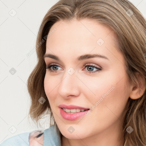 Joyful white young-adult female with long  brown hair and blue eyes