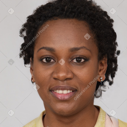 Joyful black young-adult female with short  black hair and brown eyes