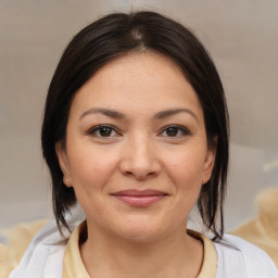 Joyful white young-adult female with medium  brown hair and brown eyes