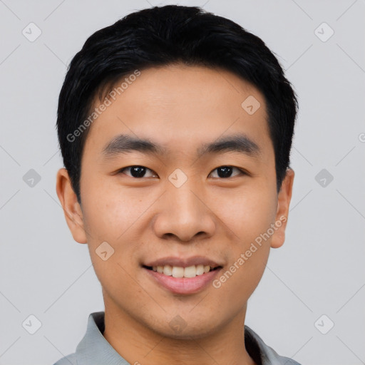 Joyful asian young-adult male with short  black hair and brown eyes