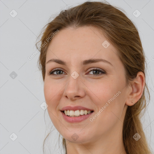 Joyful white young-adult female with long  brown hair and brown eyes