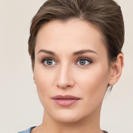 Joyful white young-adult female with short  brown hair and grey eyes