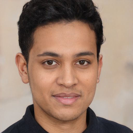 Joyful latino young-adult male with short  brown hair and brown eyes