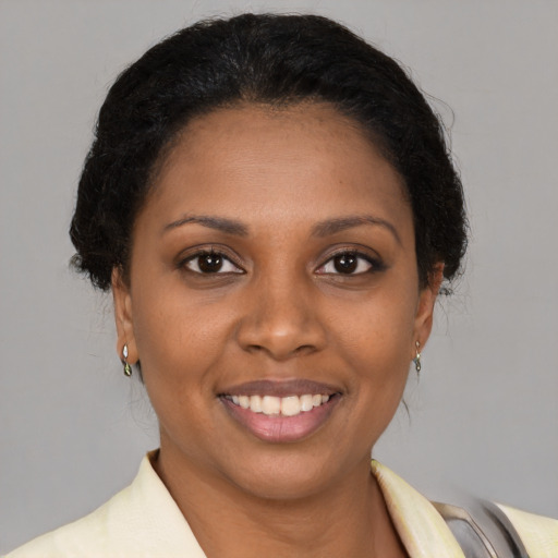 Joyful black young-adult female with medium  brown hair and brown eyes