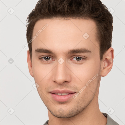 Joyful white young-adult male with short  brown hair and brown eyes