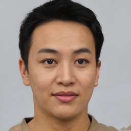 Joyful asian young-adult male with short  black hair and brown eyes