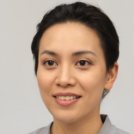 Joyful asian young-adult female with short  brown hair and brown eyes