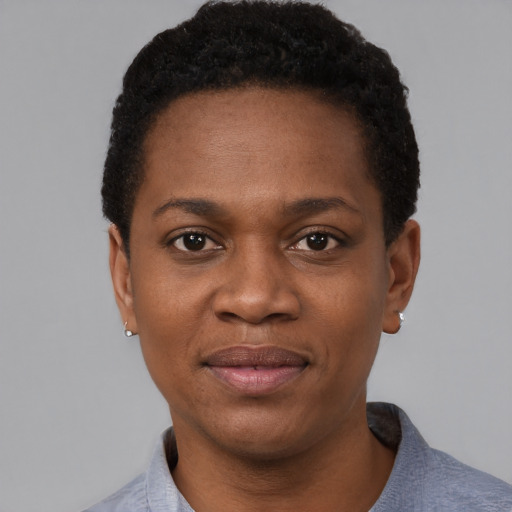Joyful black young-adult female with short  black hair and brown eyes