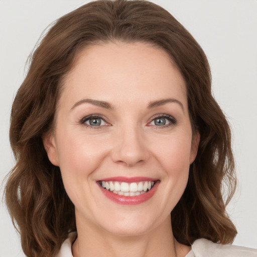 Joyful white young-adult female with medium  brown hair and green eyes