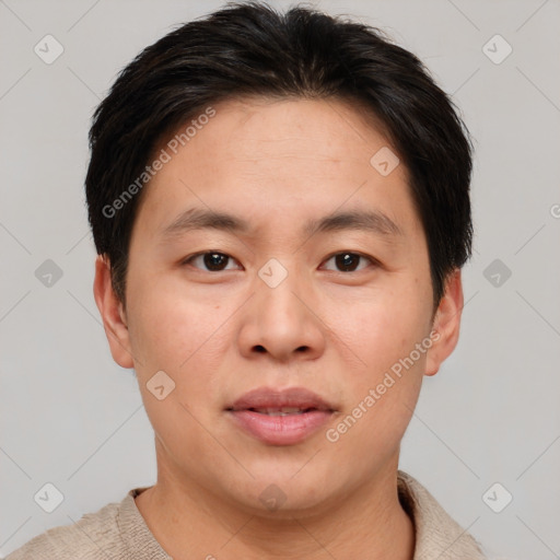 Joyful asian young-adult male with short  brown hair and brown eyes