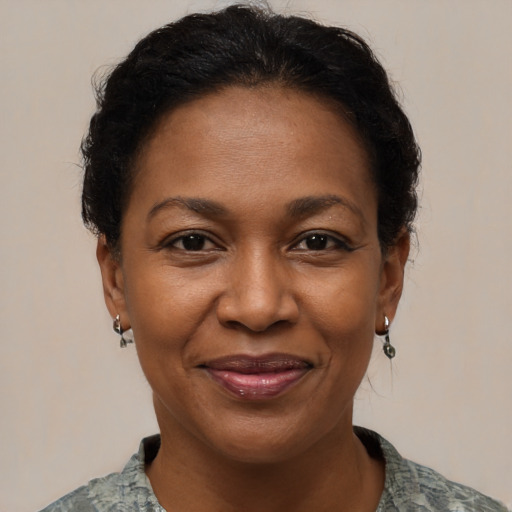 Joyful black adult female with short  brown hair and brown eyes