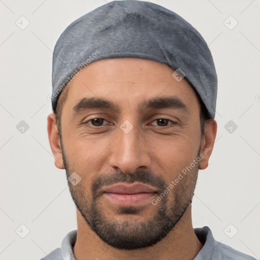 Joyful white young-adult male with short  black hair and brown eyes