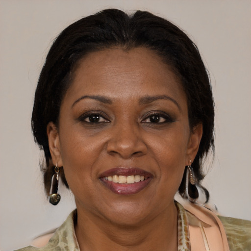 Joyful latino adult female with medium  brown hair and brown eyes