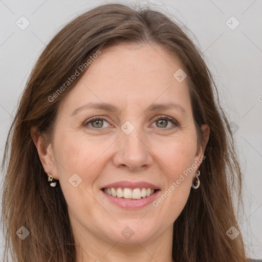 Joyful white adult female with long  brown hair and grey eyes