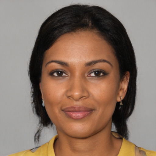 Joyful black young-adult female with medium  black hair and brown eyes